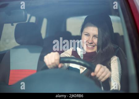 Young woman driver enjoying driving her new driving licence, transportation concept Stock Photo