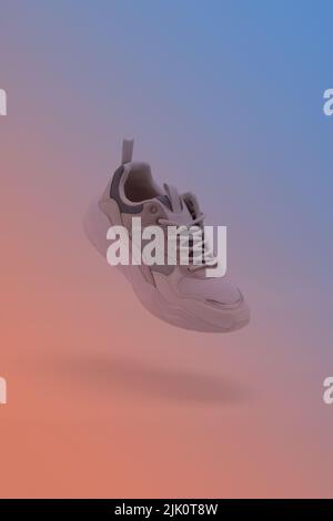Athletic Sports Shoes suspended on the air on gradient background