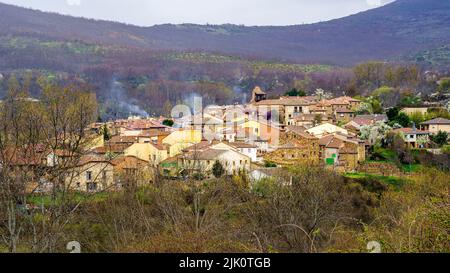 Aerial view of a medieval village in the valley between green mountains. Horcajuelo de la Sierra. Madrid. Stock Photo