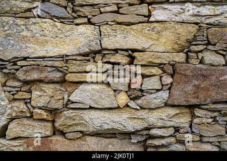 Rustic looking stone wall background used for old house construction. Madrid. Stock Photo