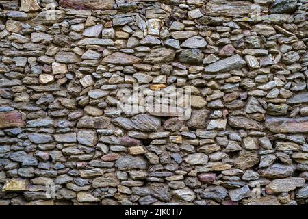 Small and medium stones wall background in medieval town of Madrid. Spain. Stock Photo
