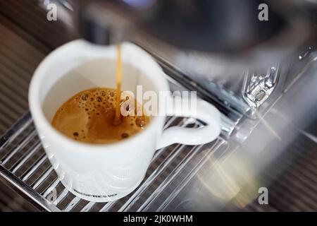 Espresso being poured from a coffee machine Stock Photo
