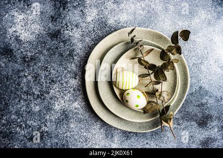 Easter minimalistic place setting with colored eggs Stock Photo