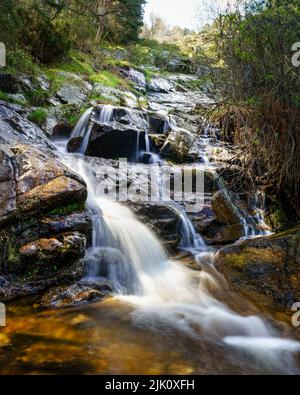 Fresh water waterfall coming down from the mountain in long exposure photo. Navacerrada Madrid Spain. Stock Photo