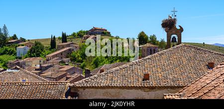 Roofs of old houses with a church tower and a stork's nest on top of the bell tower. Sepulveda Spain. Stock Photo