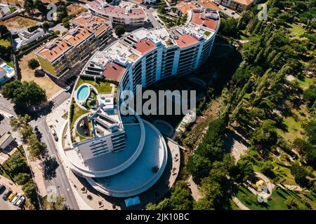 Lisbon, Portugal - July 29, 2022: Aerial drone view of luxury condominium next to Parque dos Poetas in Oerias, translated to Poet's Park Stock Photo