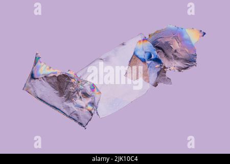 Transparent plastic film, rainbow colored by photoelasticity isolated on light purple background. Selective focus Stock Photo