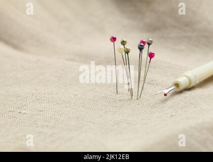 Pins with a round head in different colors, for pattern and sewing. Background with place for text. Close-up Stock Photo