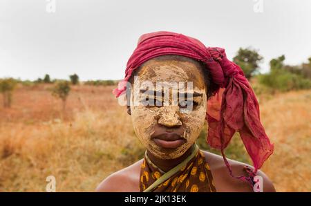 Portrait of young woman wearing dry mud, used to preserve the skin and protect from the sun, Isalo, Madagascar, Africa Stock Photo