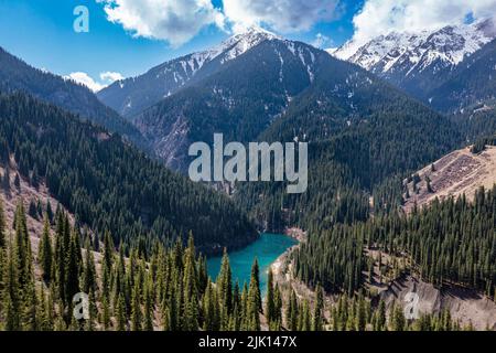 Aerial of the Kaindy Lake with its dead trees, Kolsay Lakes National Park, Tian Shan mountains, Kazakhstan, Central Asia, Asia Stock Photo