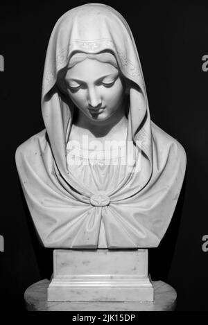 Black and white photo of marble bust of Virgin Mary as a shy young girl Stock Photo