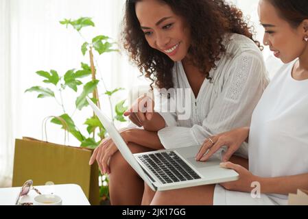 Cropped image of friends watching something interesting on laptop Stock Photo