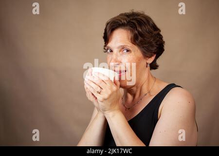 Woman enjoying a nice cup of coffee Stock Photo