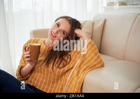 Portrait of beautiful young woman with mug of coffee Stock Photo