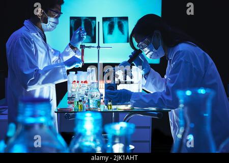 Team of scientists working on vaccine in laboratory Stock Photo