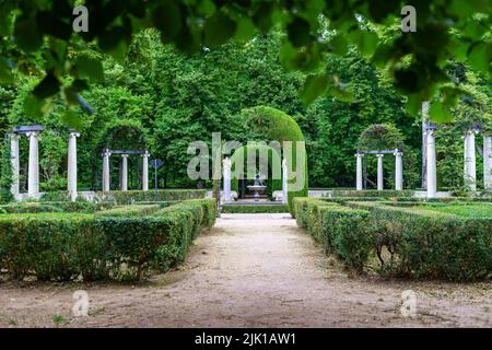 Nice corner of public park with old white stone columns and seating for lounging. Aranjuez. Stock Photo