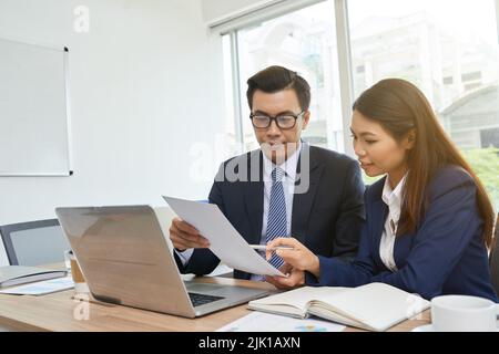 Vietnamese business team analyzing report at the meeting Stock Photo
