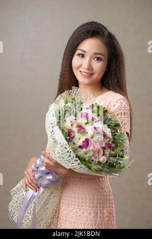 Portrait of Happy Vietnamese young woman with a big bouquet Stock Photo