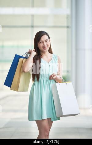 Portrait of lovely pretty Asian woman with shopping bags Stock Photo