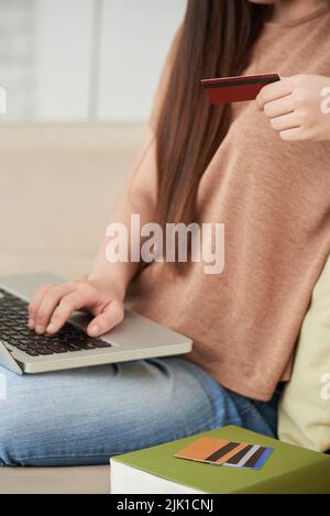 Cropped image of woman using different credit cards to make online purchases Stock Photo