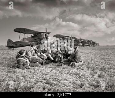 Pilots of No. 615 Squadron RAF gathered together in front of their Gloster Gladiator Mark IIs at Vitry, in Northern France. The Gloster Gladiator was a British-built biplane fighter used by the Royal Air Force (RAF) and the Fleet Air Arm (FAA) during the late 1930s. It was the RAF's last biplane fighter aircraft, and was rendered obsolete by newer monoplane designs even as it was being introduced, yet it saw action in almost all theatres during the Second World War. Stock Photo
