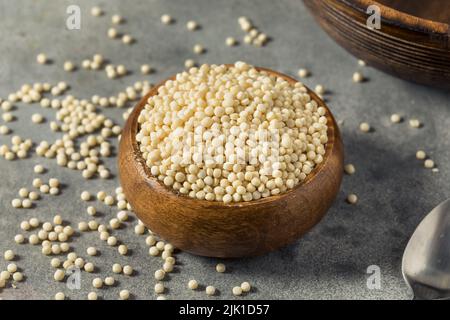 Raw Dry Organic Couscous in a Bowl Stock Photo