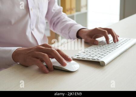 Hands of business executive working on computer Stock Photo