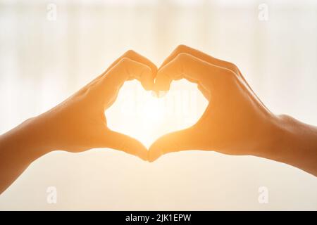Couple making heart shape with their hands Stock Photo