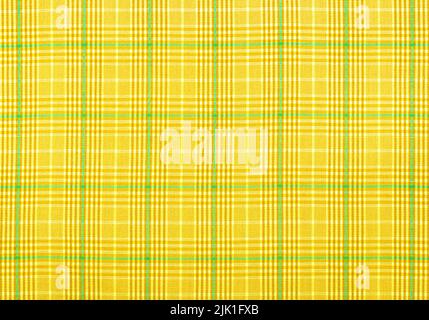 Checkered fabric in yellow . Background from checkered fabric. Material with straight lines and squares Stock Photo