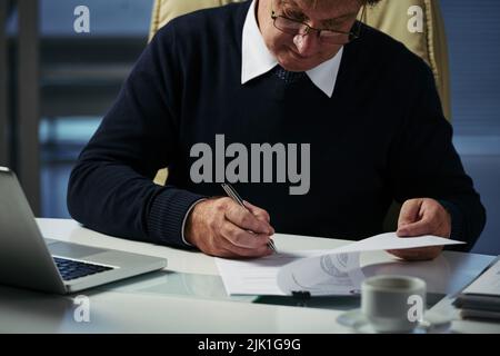 Businessman checking financial document on his table Stock Photo