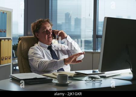 Businessman calling to colleague on the phone Stock Photo