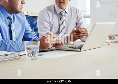 Cropped image of colleagues discussing projects and ideas at the meeting Stock Photo