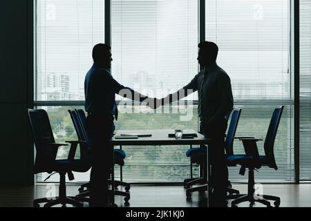 Business executives shaking hands to greet each other Stock Photo