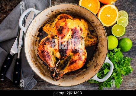 Cuban Mojo Chicken Roasted in a Dutch Oven: Whole roast chicken seasoned with a citrus garlic marinade Stock Photo