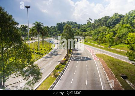 Unusual empty highway in the malaysia capital Kuala Lumpur near  Jalan Parlimen. Where normally car follows car and daily traffic jam the air polluted Stock Photo