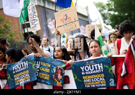 Turin, Italy. 29 July 2022. Patience Nabukalu is seen among activists during a demonstration against government action towards climate breakdown and environmental pollution. The demonstration was organized by Fridays For Future movement and followed five days of Climate Social Camp an international event which brought together activists from around the world. Credit: Nicolò Campo/Alamy Live News Stock Photo