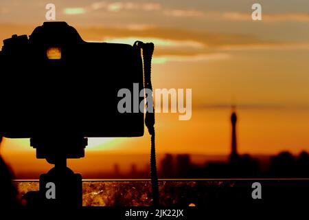 Photo camera taking sunset pictures of Eiffel Tower in Paris, France Stock Photo