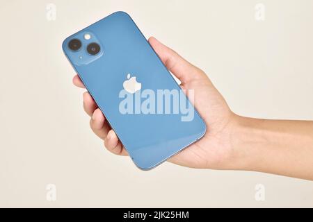 New Delhi, India -  June 22, 2022: Iphone 13 in hand isolated on white background Stock Photo