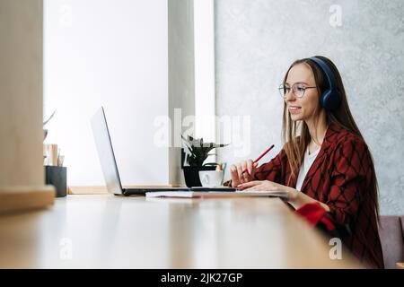 Outsourcing IT Projects, remote work, young professionals. female young programmer, developer working Stock Photo