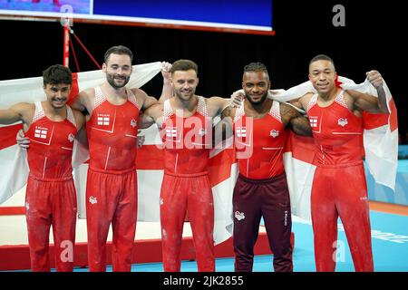 The England team (left to right) Jake Jarman, James Hall, Giarnni Regini-Moran, Courtney Tulloch and Joe Fraser celebrate after winning the Men's Team Final at Arena Birmingham on day one of the 2022 Commonwealth Games in Birmingham. Picture date: Friday July 29, 2022. Stock Photo