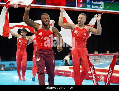 The England team (left to right) Jake Jarman, Courtney Tulloch and Joe Fraser celebrate after winning the Men's Team Final at Arena Birmingham on day one of the 2022 Commonwealth Games in Birmingham. Picture date: Friday July 29, 2022. Stock Photo