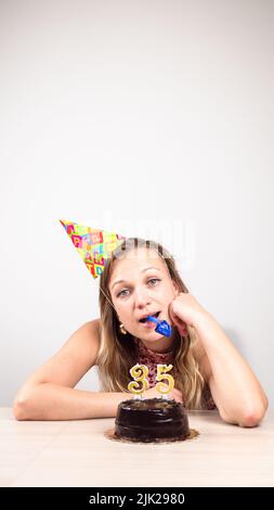 a woman celebrates her birthday alone. beautiful sad woman clebrating her birthday alone Stock Photo