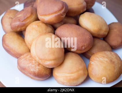 Delicious sweet donuts on a plate. close up. Traditional Jewish sweet dish from Hanukkah Stock Photo