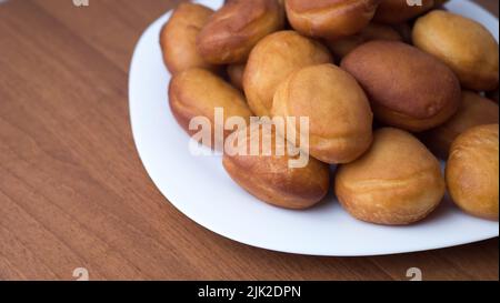 Delicious sweet donuts on a plate. close up. Traditional Jewish sweet dish from Hanukkah Stock Photo