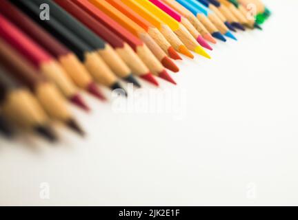 Many different colored pencils on white background. Copy space. selective focus