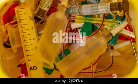 Interior of a yellow Container for hazardous hospital biological waste with syringes, needles, catheters, blood samples... Stock Photo