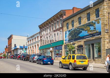 Cars drive in downtown Gananoque Ontario Canada on a sunny day. Stock Photo