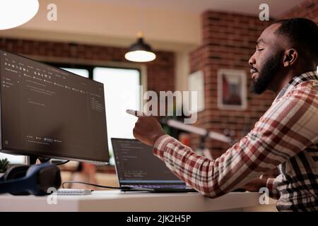 Web developer writing program code and html data base on new user interface. Male freelancer using terminal window and developing online app cloud server, learning coding language. Stock Photo
