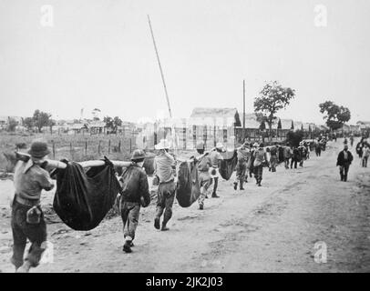 Photograph of American prisoners using improvised litters to carry comrades on the Bataan Death March. The March of Death in the Philippines was about May 1942, from Bataan to Cabanatuan, the prison camp Stock Photo