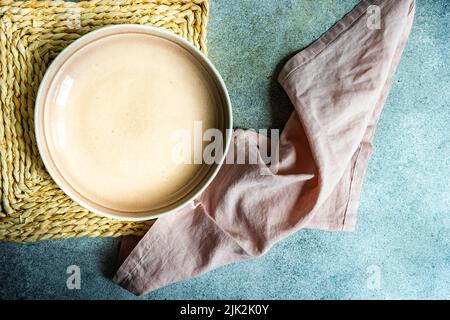 Rustic table setting with ceramic plate on concrete table Stock Photo